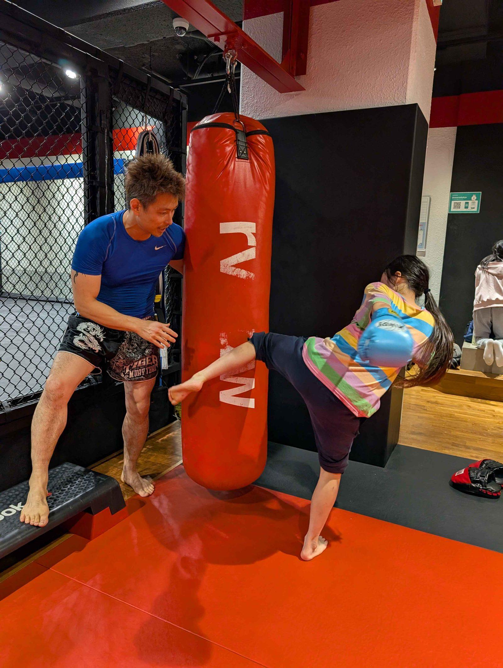 Kid kicking a heavy bag